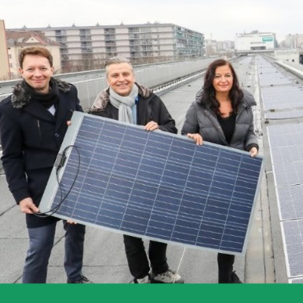 Representatives of City of Vienna hold PV foil on the roof of Ottakring metro station 