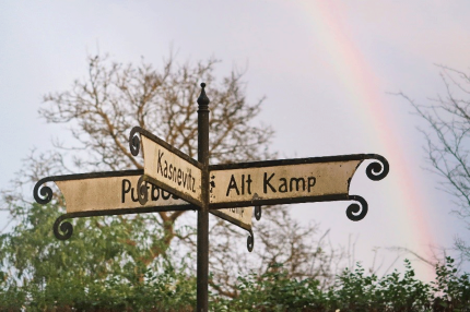 Historical Signposts with Rainbow - Photo by Sabine Eisenknappl 